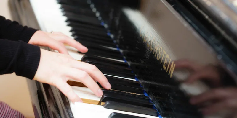 Hands playing piano