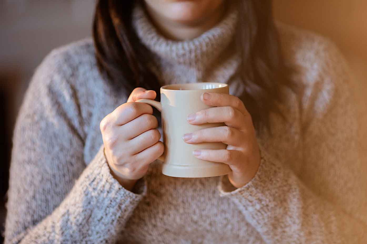 Woman holding mug of tea